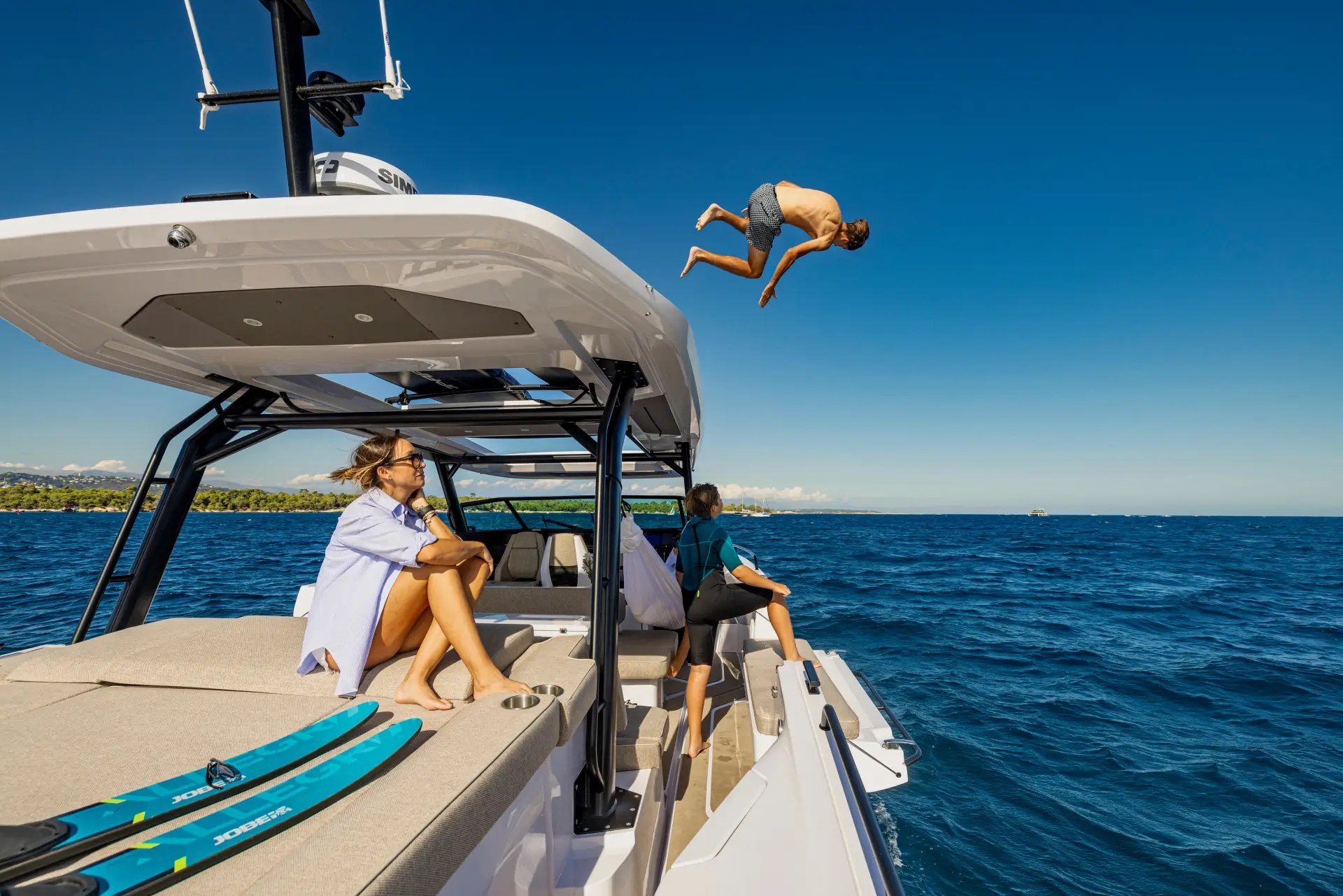 Guest leaping off the roof of the Axopar 45 into the sea